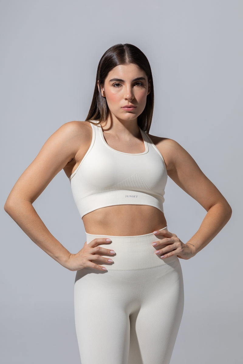 Model wearing The Seamless Bra Top in cream with matching cream leggings, front view
