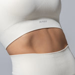 Close-up of the ribbed fabric and underband on The Seamless Bra Top in cream
