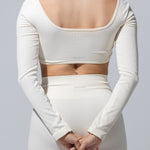 The Seamless Long Sleeve Top in cream, back view showing the open scoop back