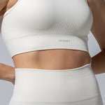 Side close-up of The Seamless Bra Top in cream showing the ribbed texture