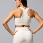 Back view of The Seamless Legging in cream with a cream bra top